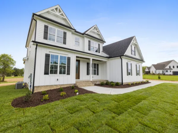  Modern suburban house with fresh landscaping and green lawn