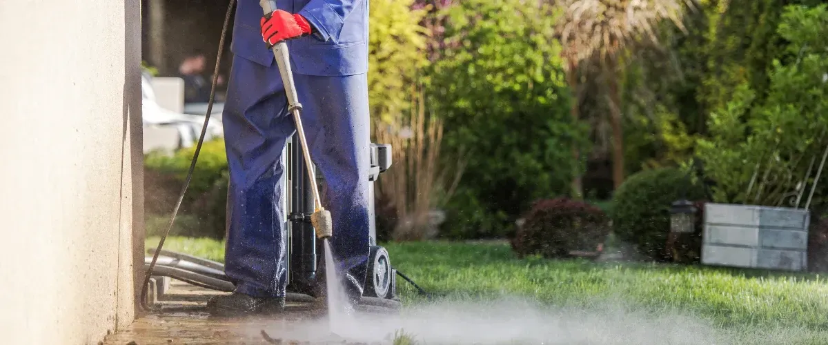 Professional pressure washing service cleaning a concrete driveway.