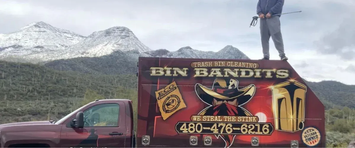 Bin Bandits truck for eco-friendly trash bin cleaning parked in front of scenic mountains