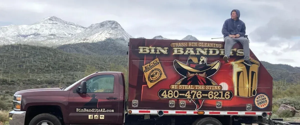 Bin Bandits trash bin cleaning truck with mountain backdrop in Arizona