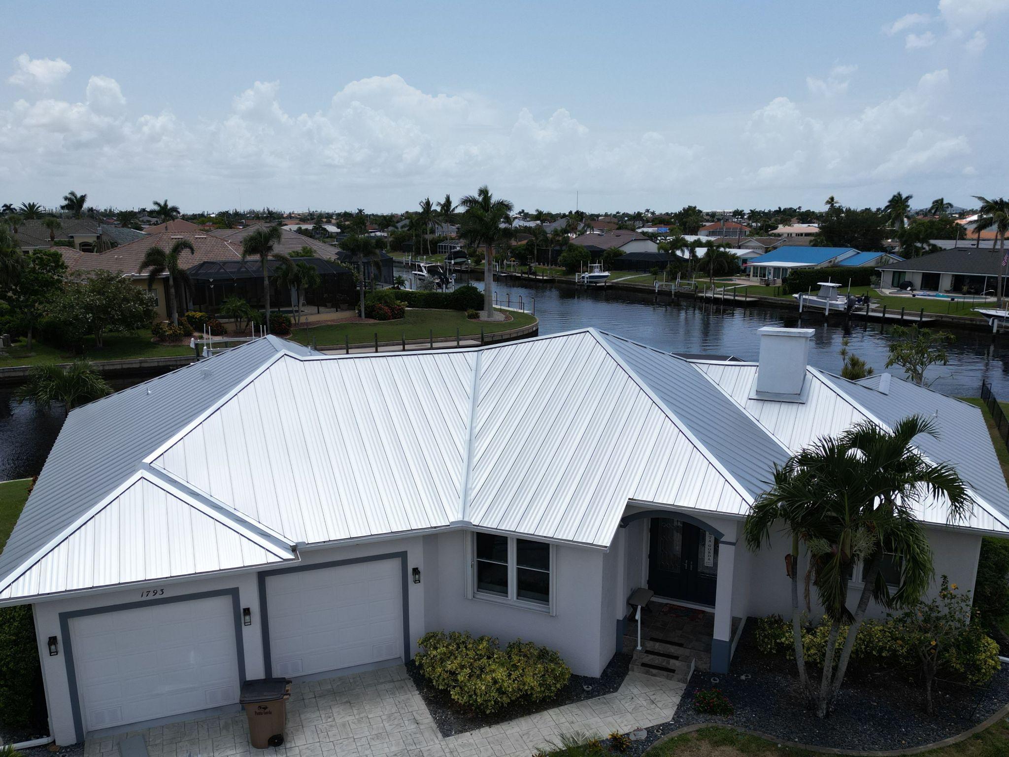 Custom residential gray standing seam metal roof installation by GMS Roofing and Construction LLC providing a sleek, modern aesthetic and lifetime weather protection.