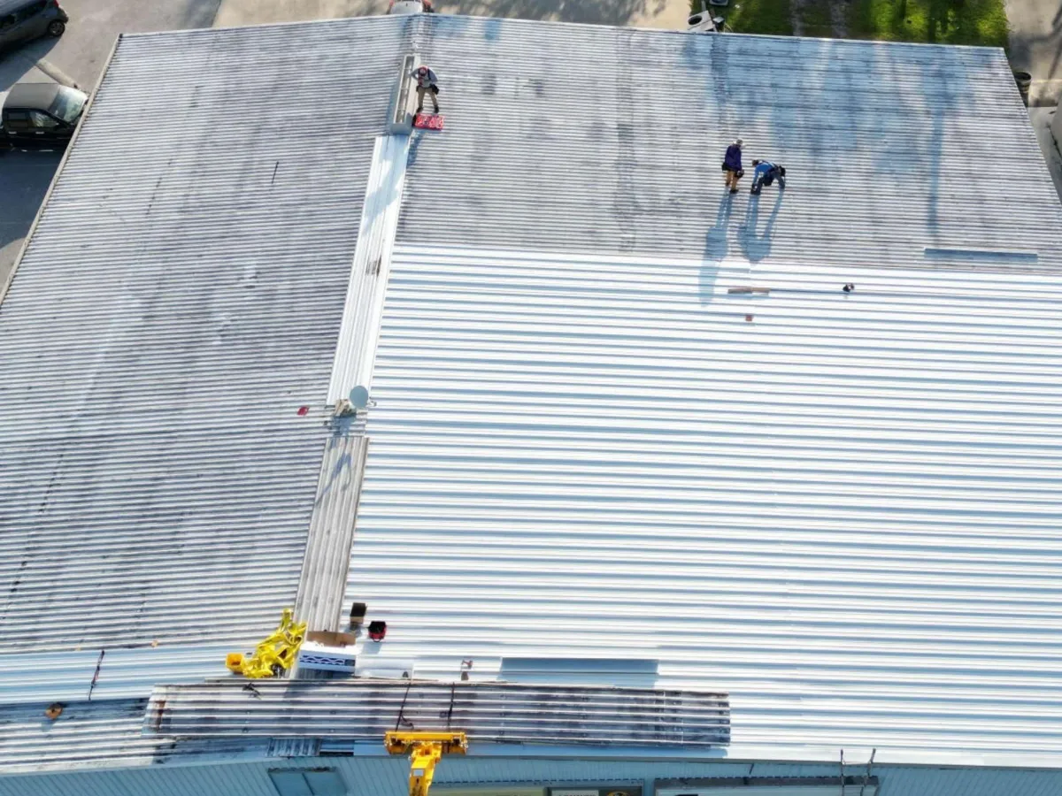 Large-scale commercial metal roof repair and full system replacement on an industrial building by GMS Roofing and Construction LLC
