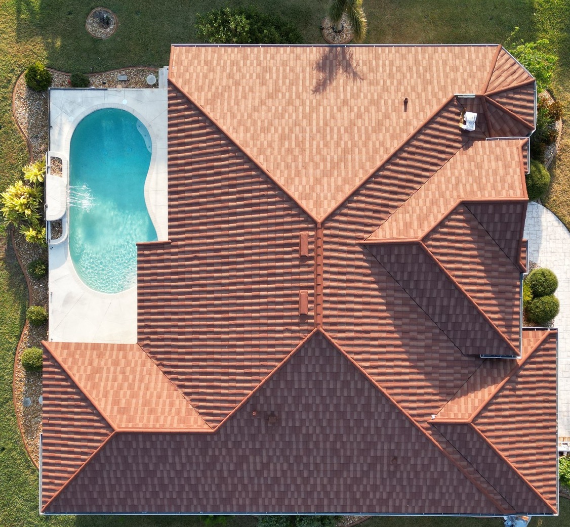 Residential roof with severe wind damage showing architectural shingles blown away and exposed underlayment before repair by GMS Roofing and Construction LLC.