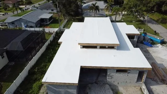 Energy-efficient white TPO rubber roofing system installed on a new construction home by GMS Roofing and Construction LLC