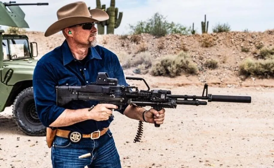 Photo of Sheriff Mark Lamb shooting a rifle in the desert
