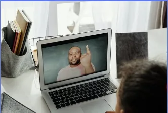 A black man talking in the laptop