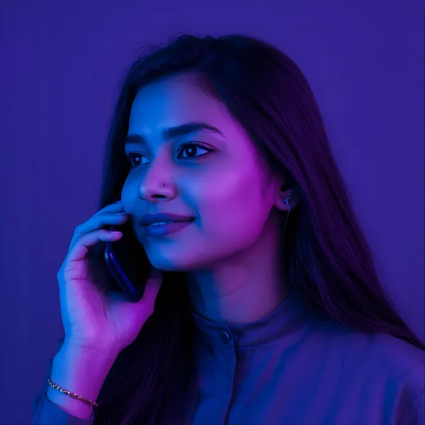 Woman on a phone call, brightly lit with purple and blue tones, looking slightly upward with a calm expression.