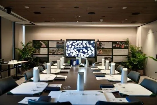 person holding black red yellow and green round analog clock