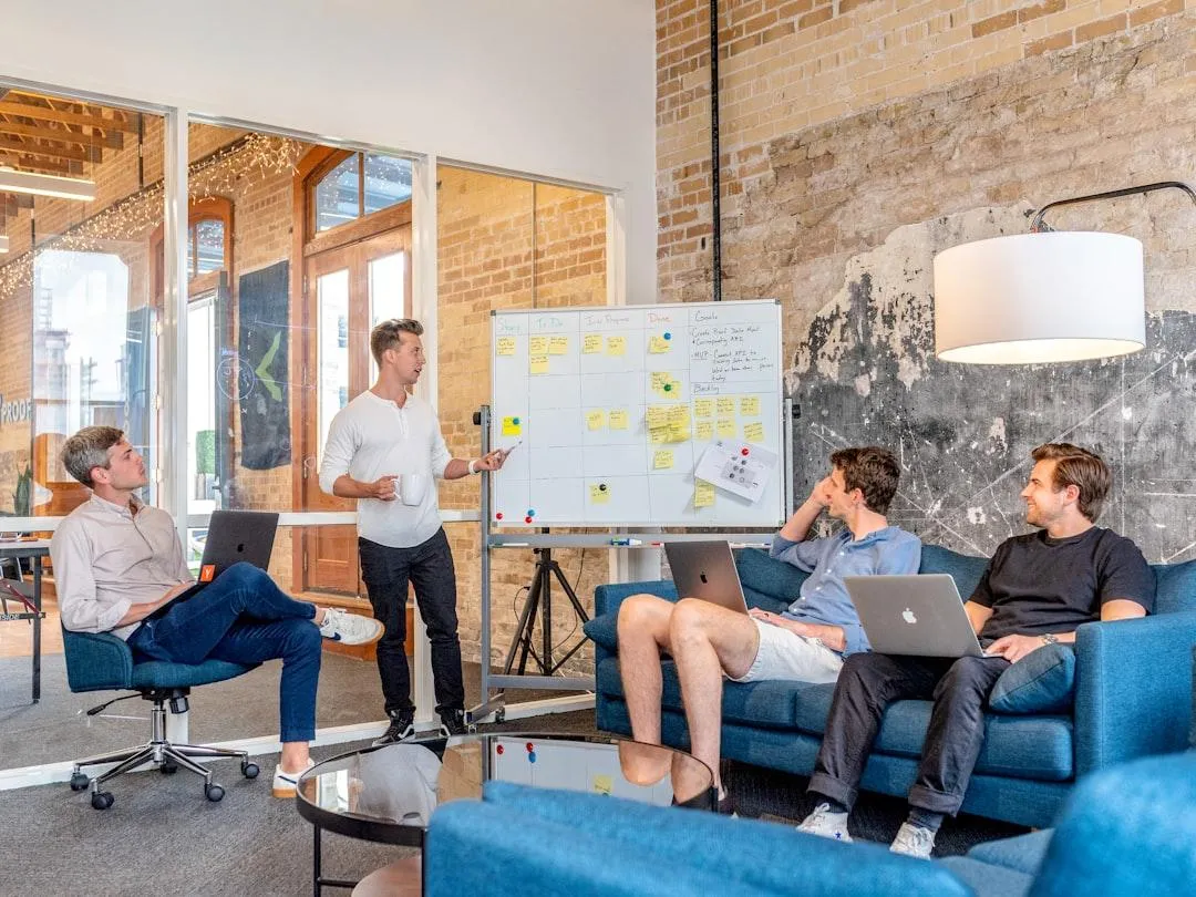 Digital marketing team strategizing around a white board.