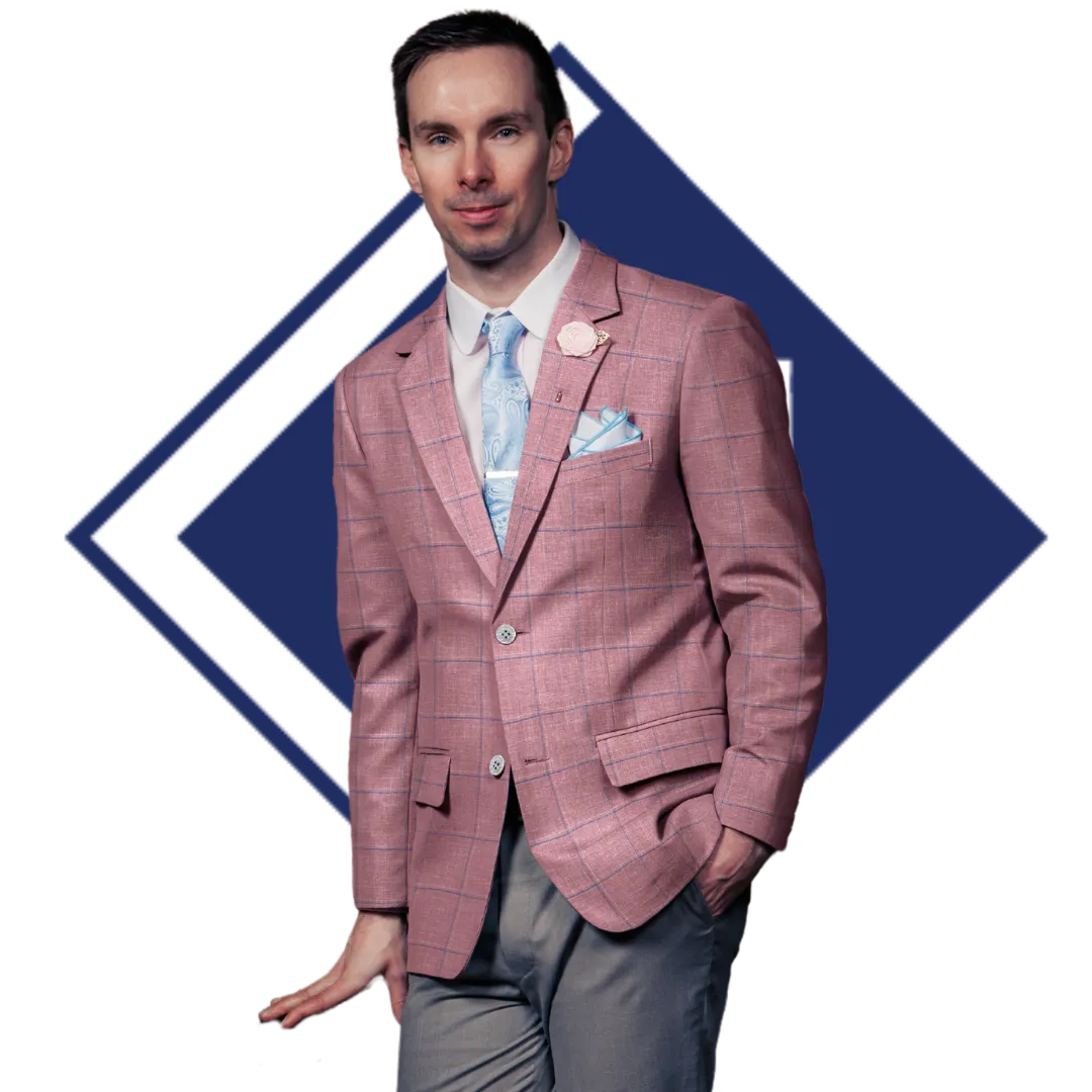 A man in a custom made to measure outfit with a light pink jacket and grey dress pants.