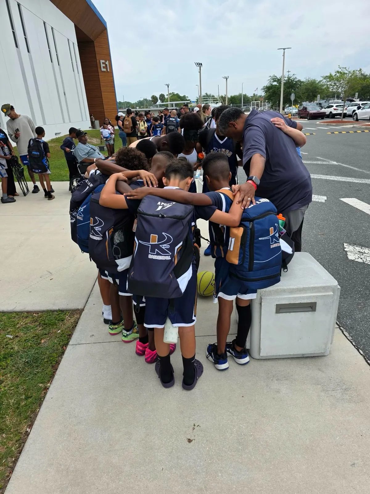 Coach Wiggins praying with his team
