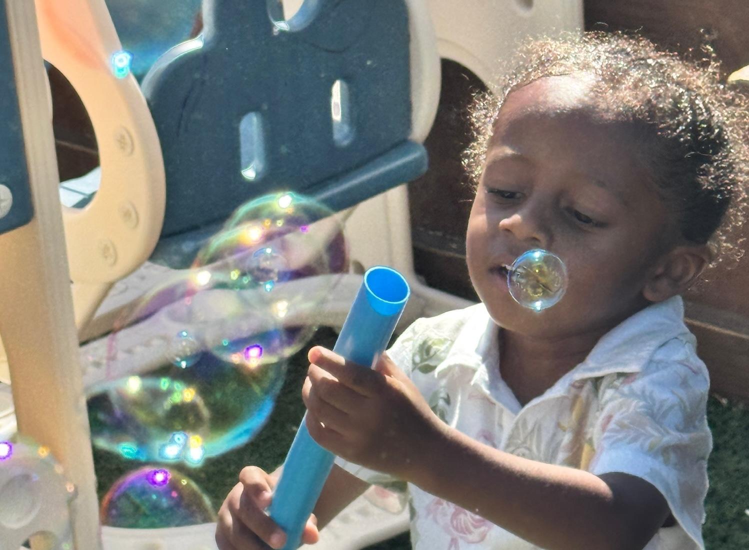 Boy picks paper out of different colored liquids