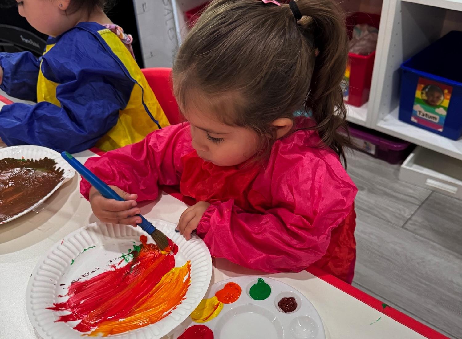 Girl follows directions during arts and crafts time.