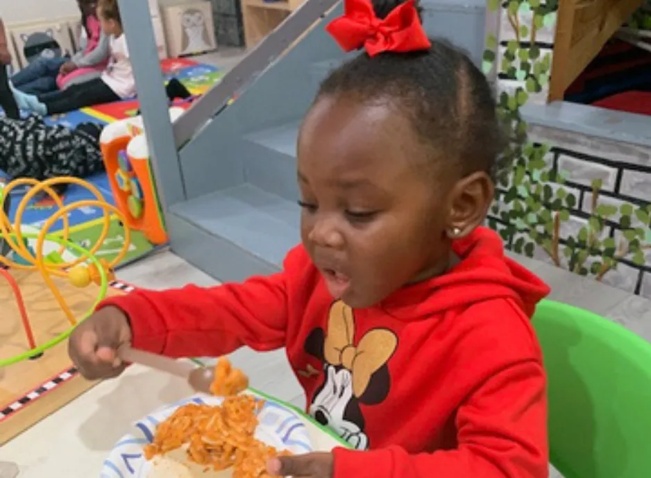 Child waves at laptop