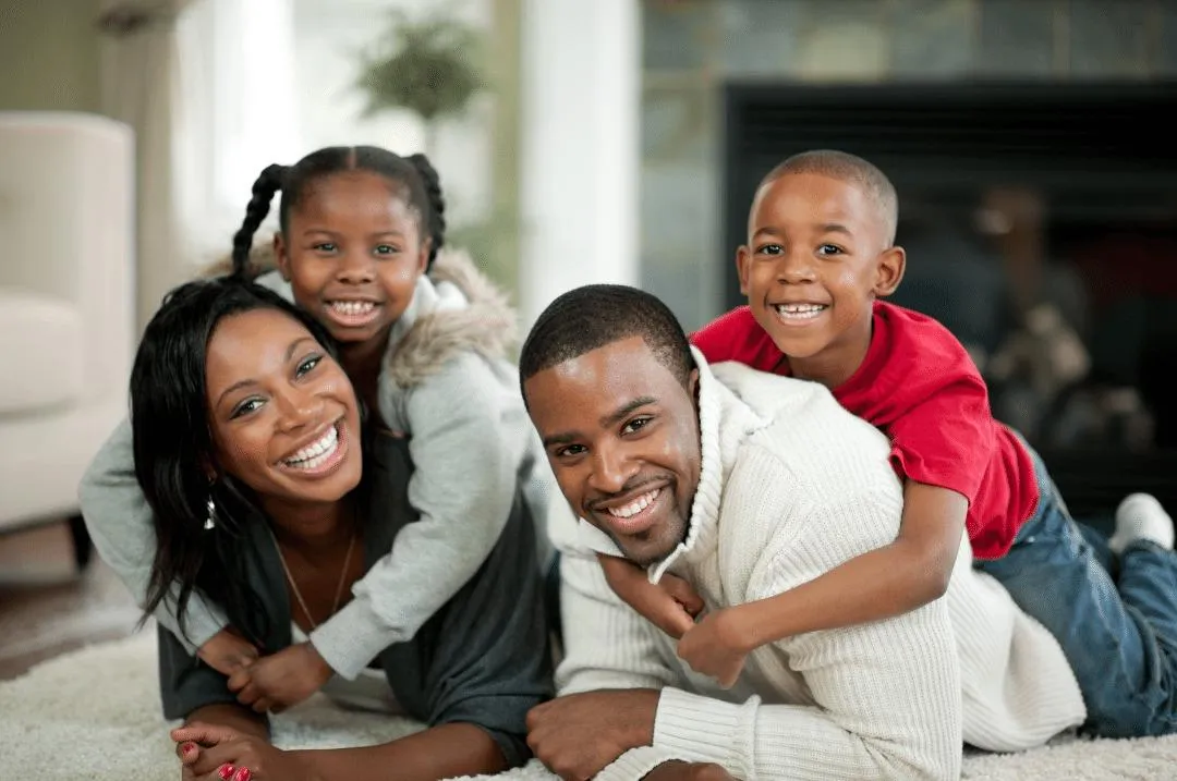 man in white shirt carrying boy