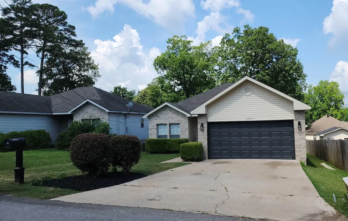 A modern kitchen with navy blue cabinets, light gray walls, and a glossy, easy-to-clean finish, demonstrating a specialty coating application.
