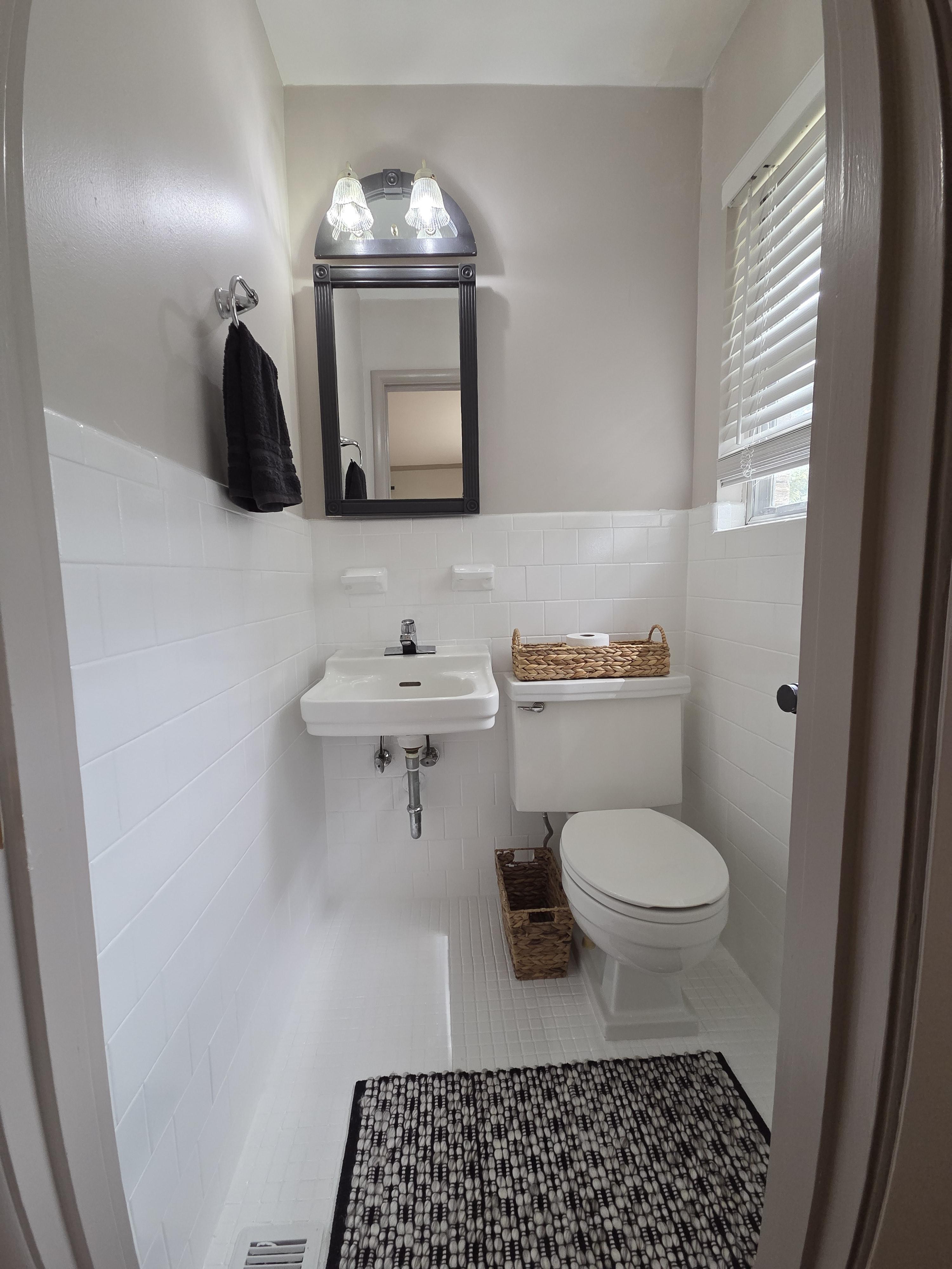 A modern kitchen with navy blue cabinets, light gray walls, and a glossy, easy-to-clean finish, demonstrating a specialty coating application.