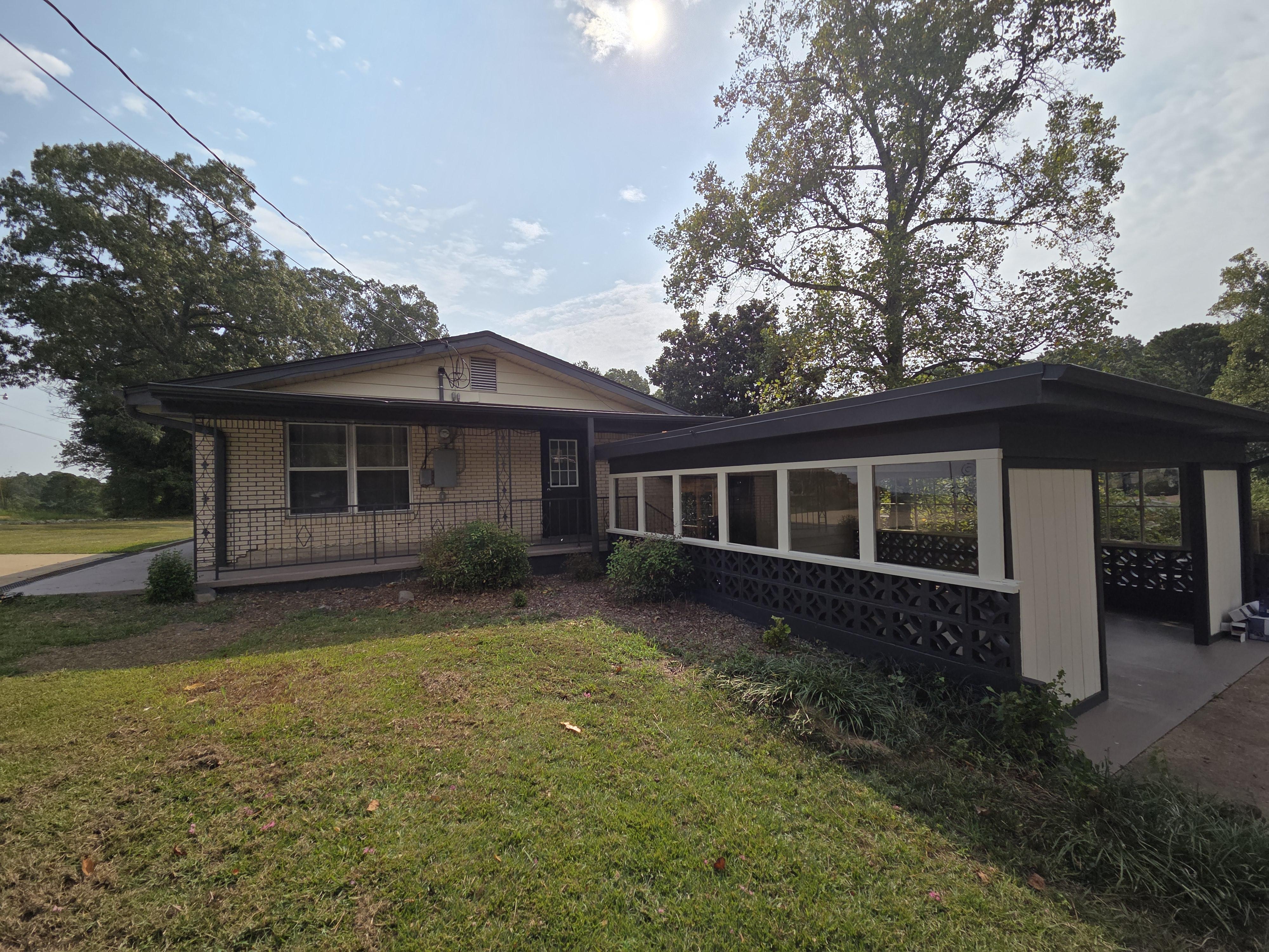 A modern kitchen with navy blue cabinets, light gray walls, and a glossy, easy-to-clean finish, demonstrating a specialty coating application.