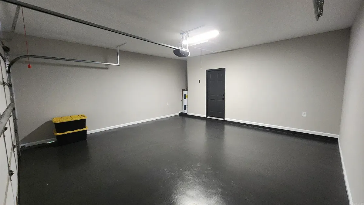 A modern kitchen with navy blue cabinets, light gray walls, and a glossy, easy-to-clean finish, demonstrating a specialty coating application.