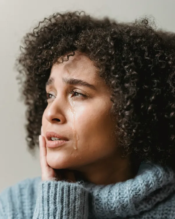 Woman looking to the side and crying