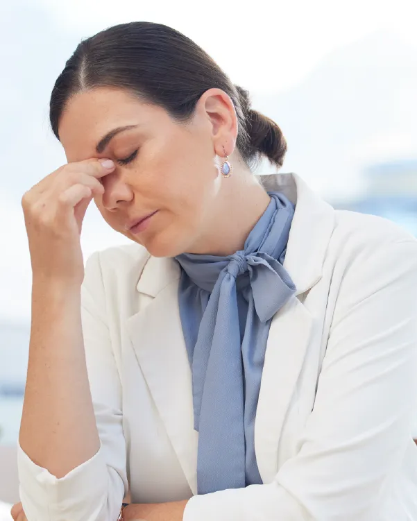 Woman resting her hand near her face, reflecting feelings of fatigue, stress, or overwhelm