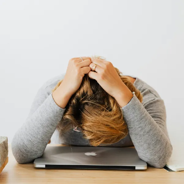 Exhausted woman with her head down on her desk