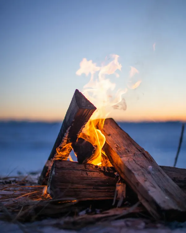 Campfire by the ocean at sunset