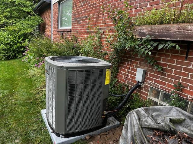 Professional installing and testing an air conditioning system.