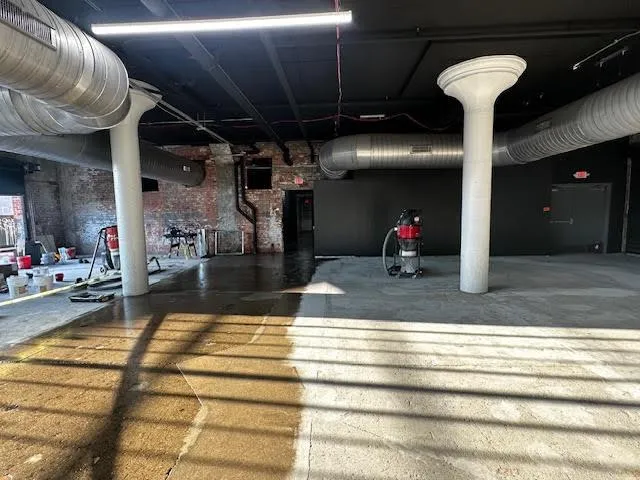 Technicians installing a large commercial HVAC system in a building.