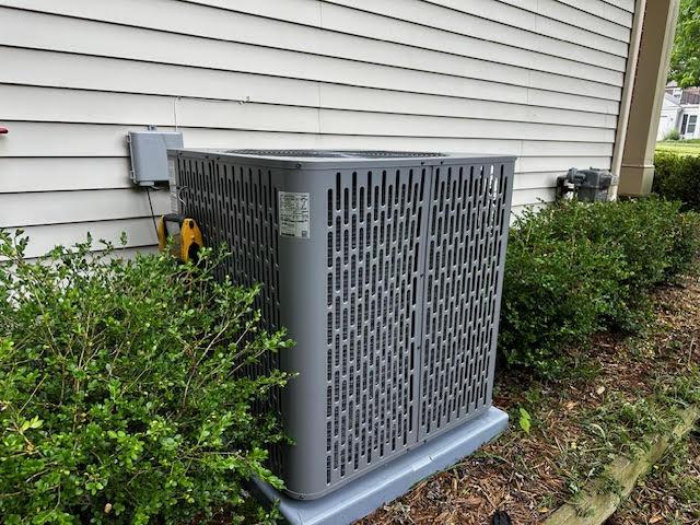 HVAC specialist installing a new residential air conditioning unit.