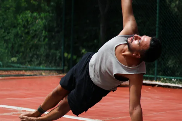 Athlete on active recovery day doing light activity like walking or stretching, looking relaxed with Grip Hydra nearby 