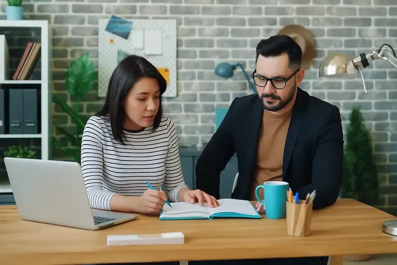 Two professionals collaborating on tax strategy in a modern office setting