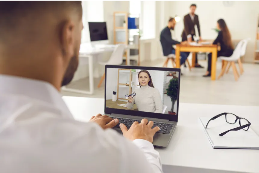 Man conducting a one-on-one meeting with a client using a laptop