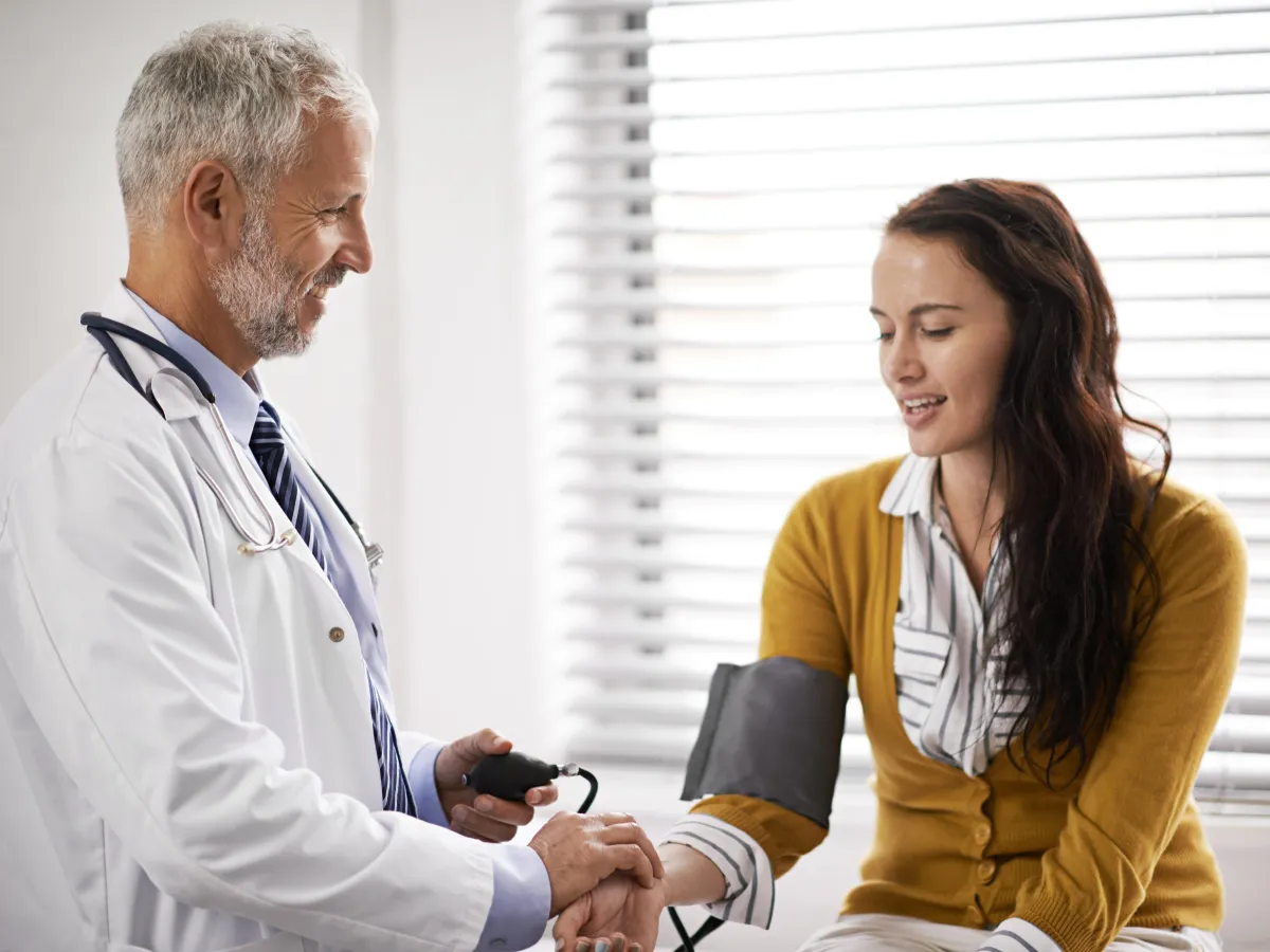 Doctor checking a patient's blood pressure