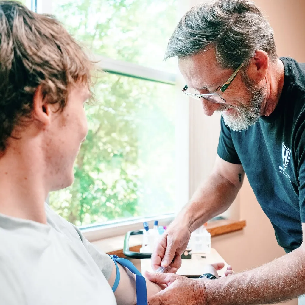 Dr. Herald performing a lab draw on a patient