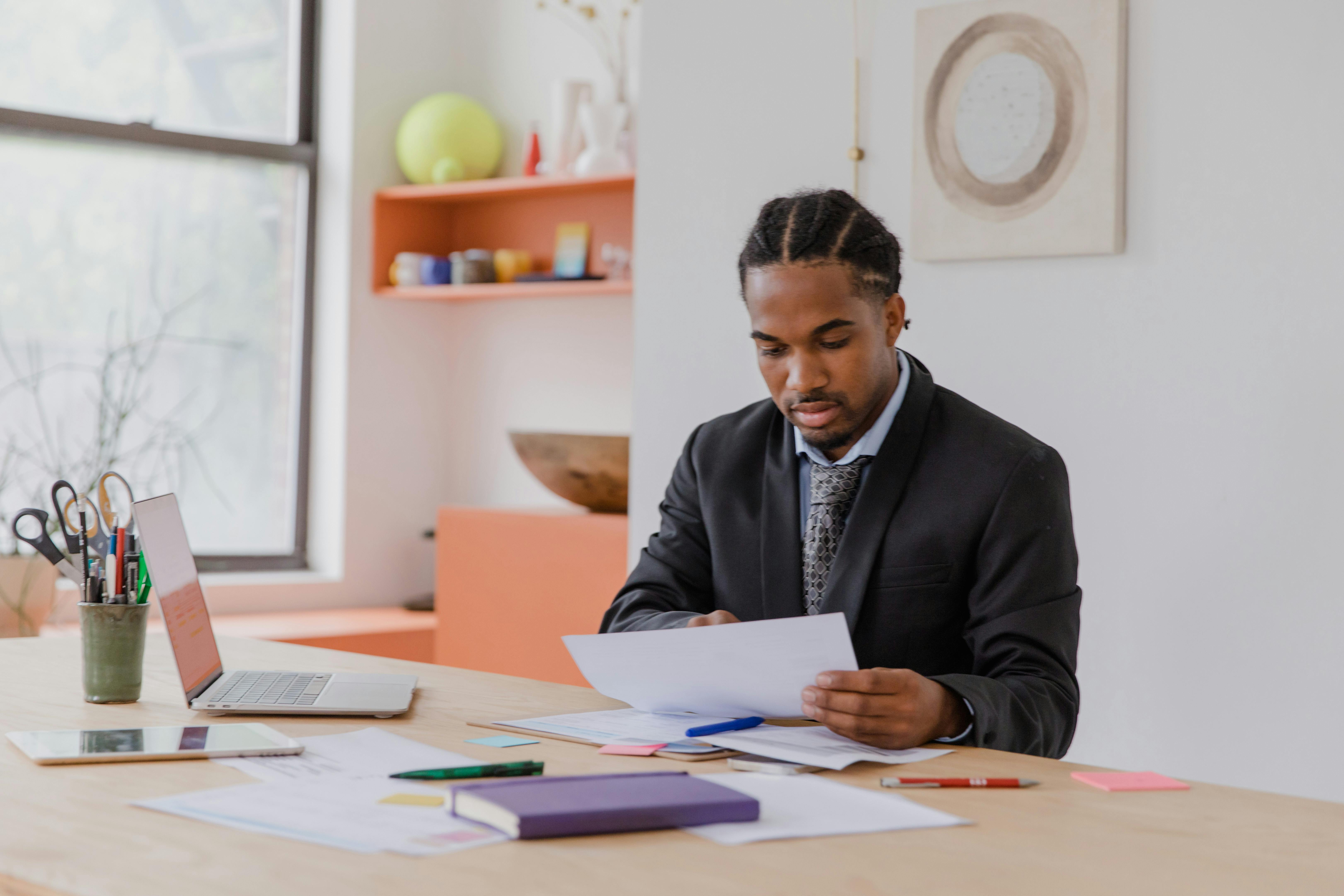 Focused businessman reviewing documents in a modern office setting