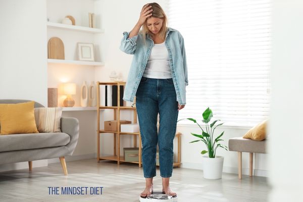 woman staring down at scales feeling disillusioned
