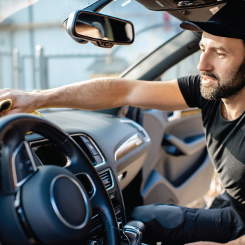 Man cleaning dash