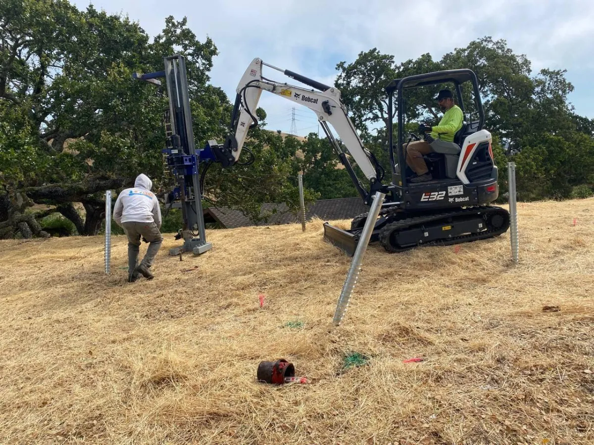Tractor setting the holes for ground mount solar