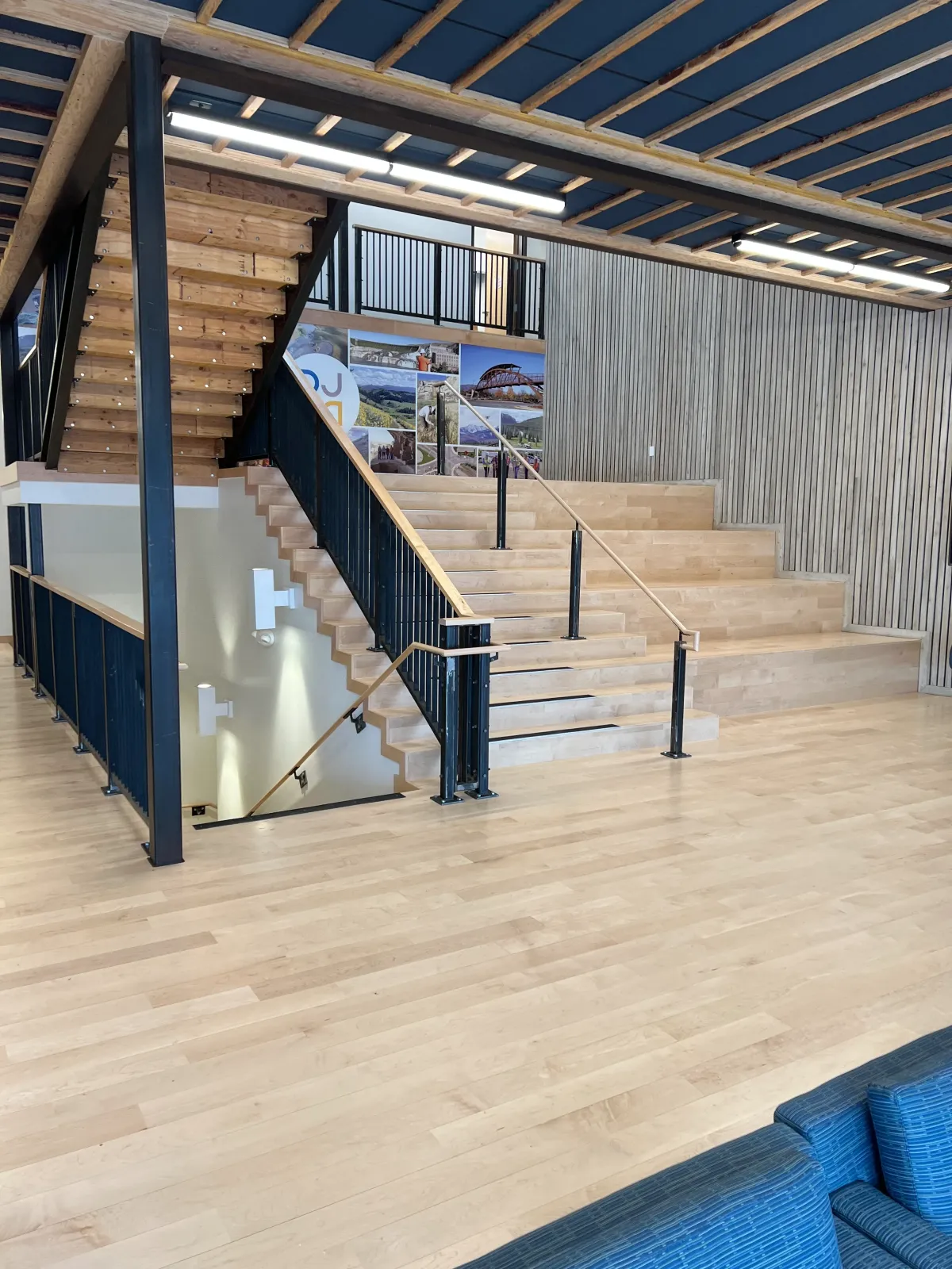 Professional hardwood floor installation in Missoula MT with custom wood stairs and modern commercial interior by Winnwood Flooring