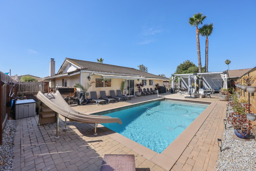 a modern house with a pool in the middle of the yard