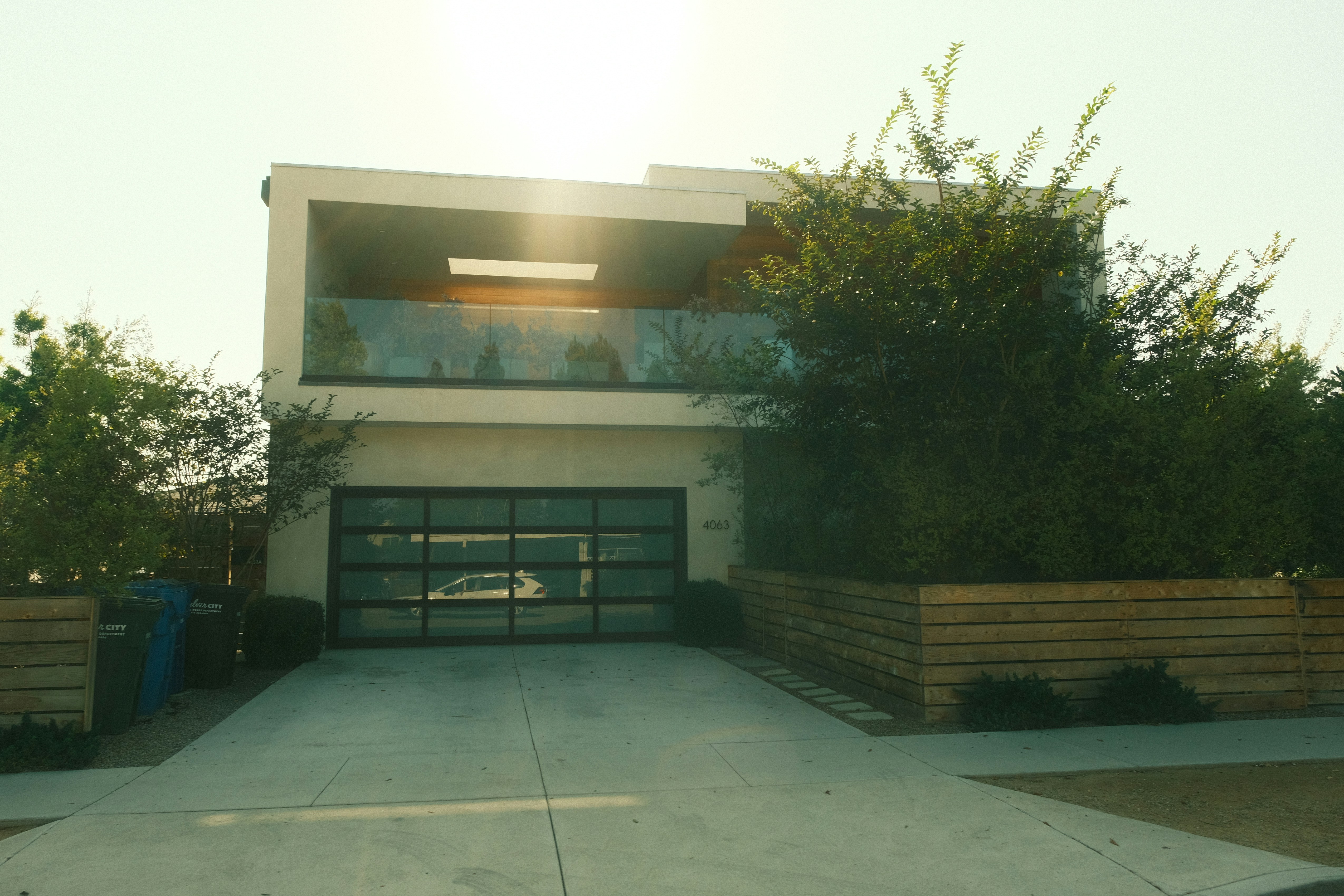 concrete residence with a plain concrete driveway coming out from garage