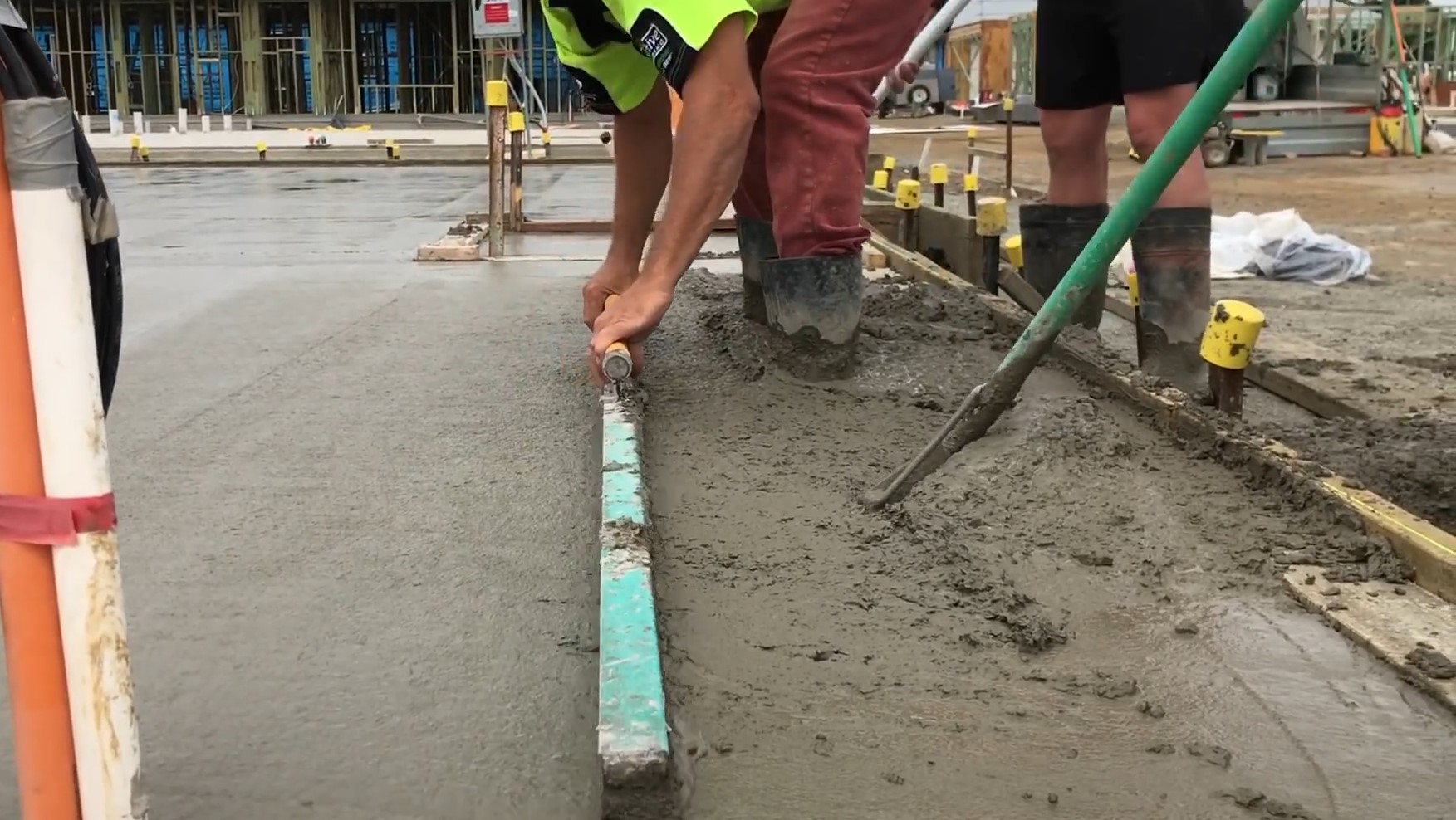 concrete beeing screeded using screed bar