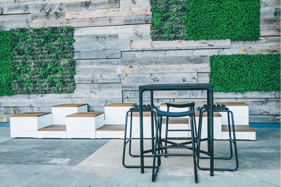 concrete patio area with black chairs and seats