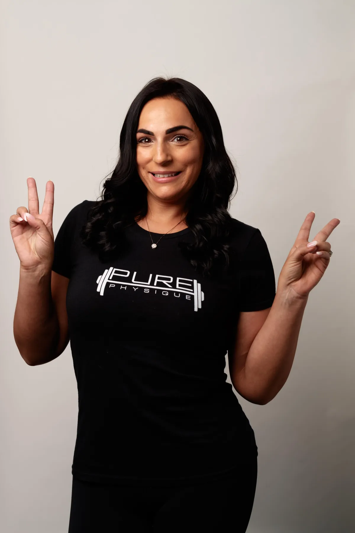 woman in black shirt and blue denim jeans sitting on black exercise equipment