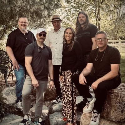The Revels logo with band members: Lindon, Jody Ryan Darren, Oliver, and Scott