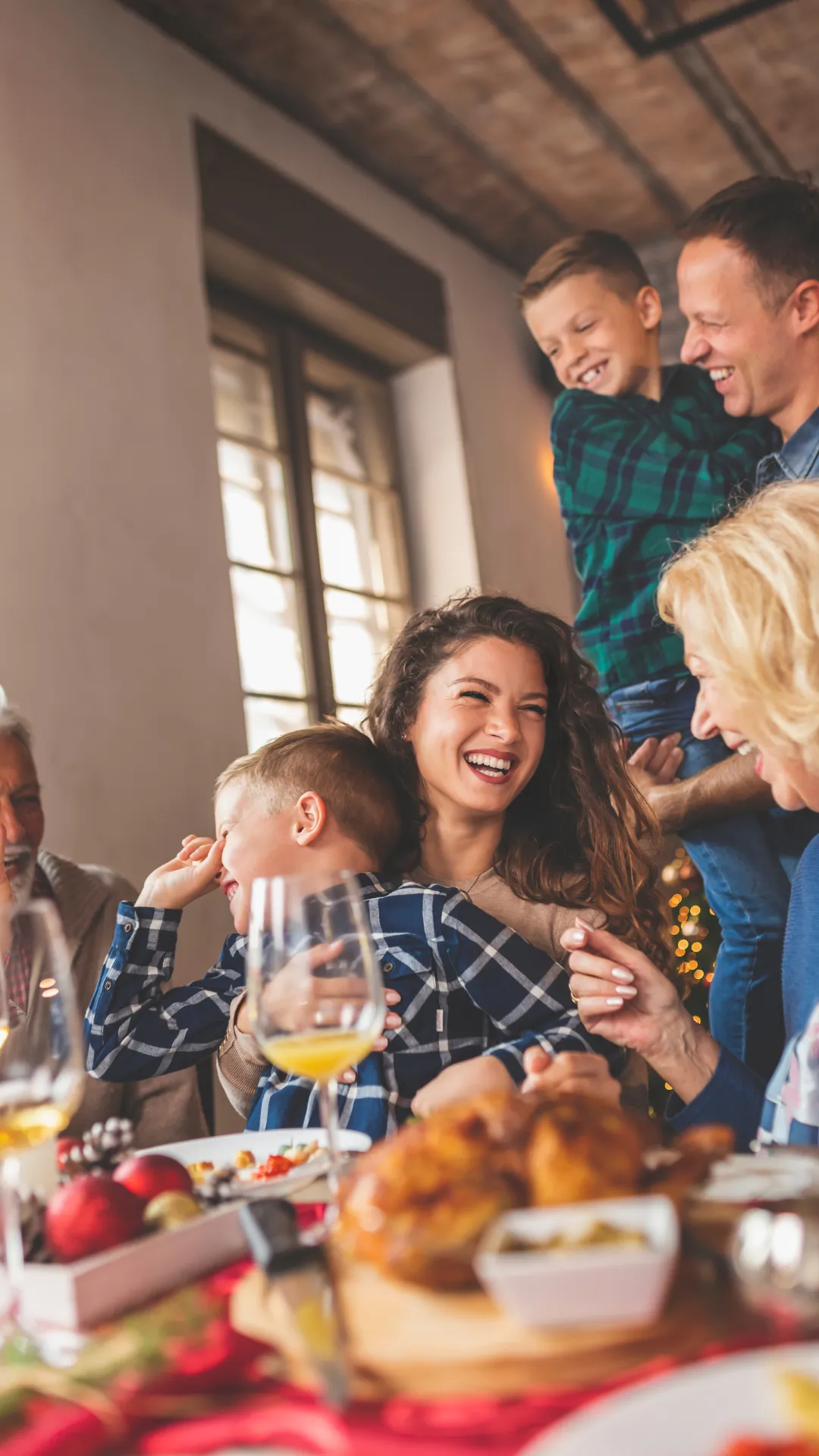 family laughing, woman in center is a business owner who is not worried about the stress of the holidays