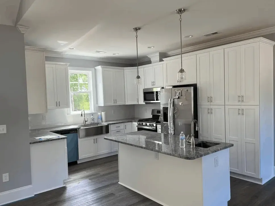 recently remodeled kitchen in Jacksonville NC with modern cabinetry, granite island, and stainless steel appliances