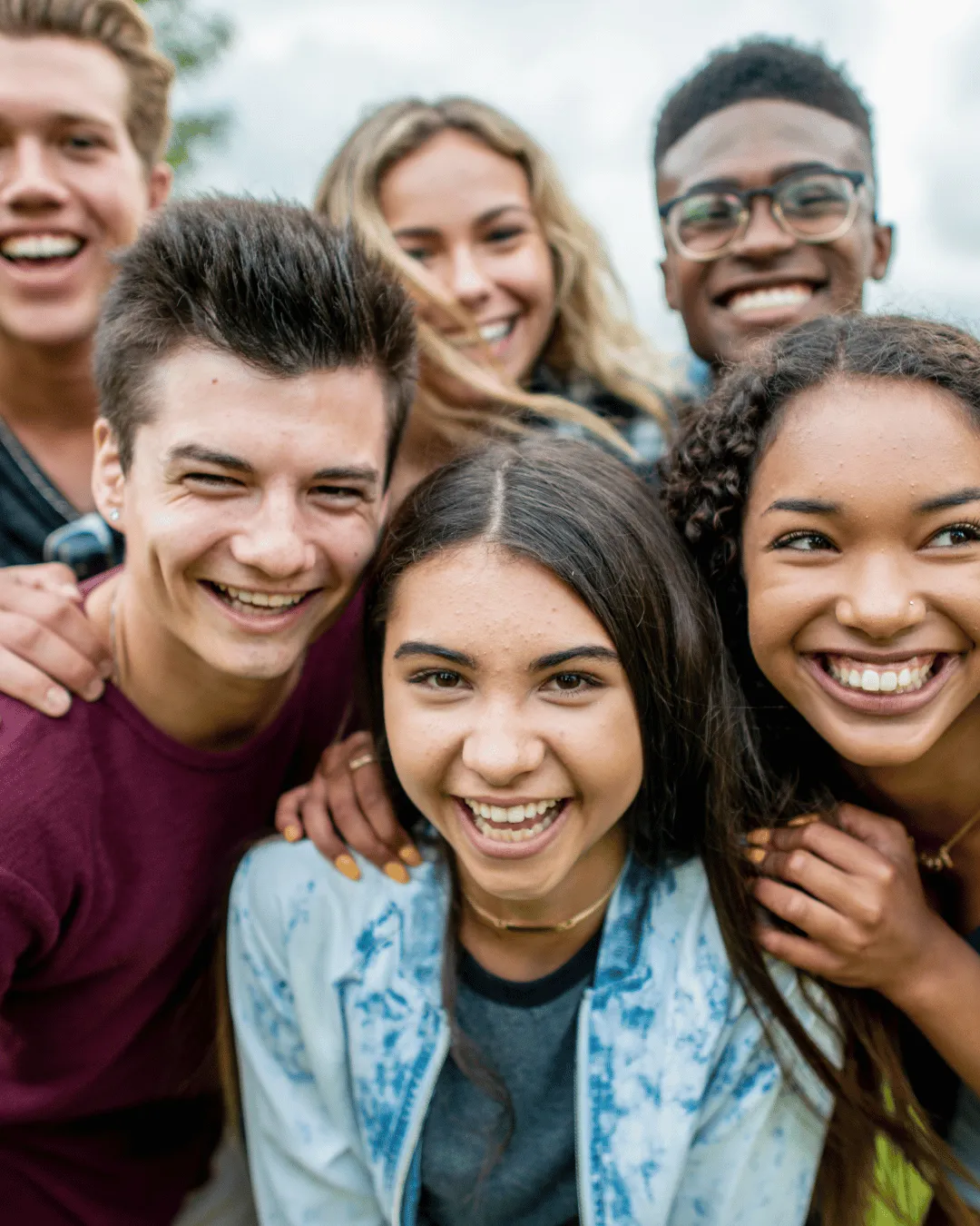Diverse teens walking toward soft golden light together