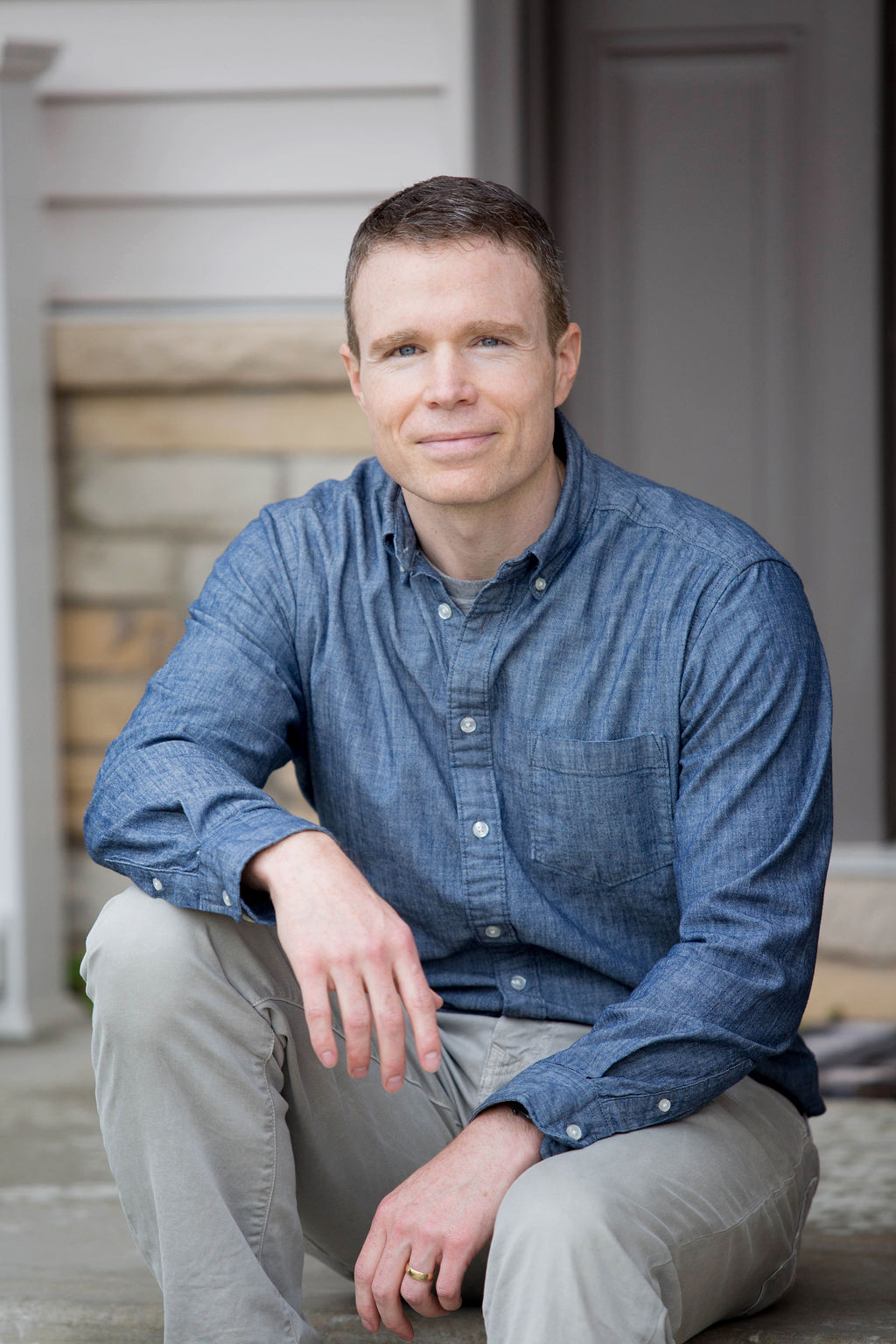 Dr. Todd on front porch in denim shit and khakis